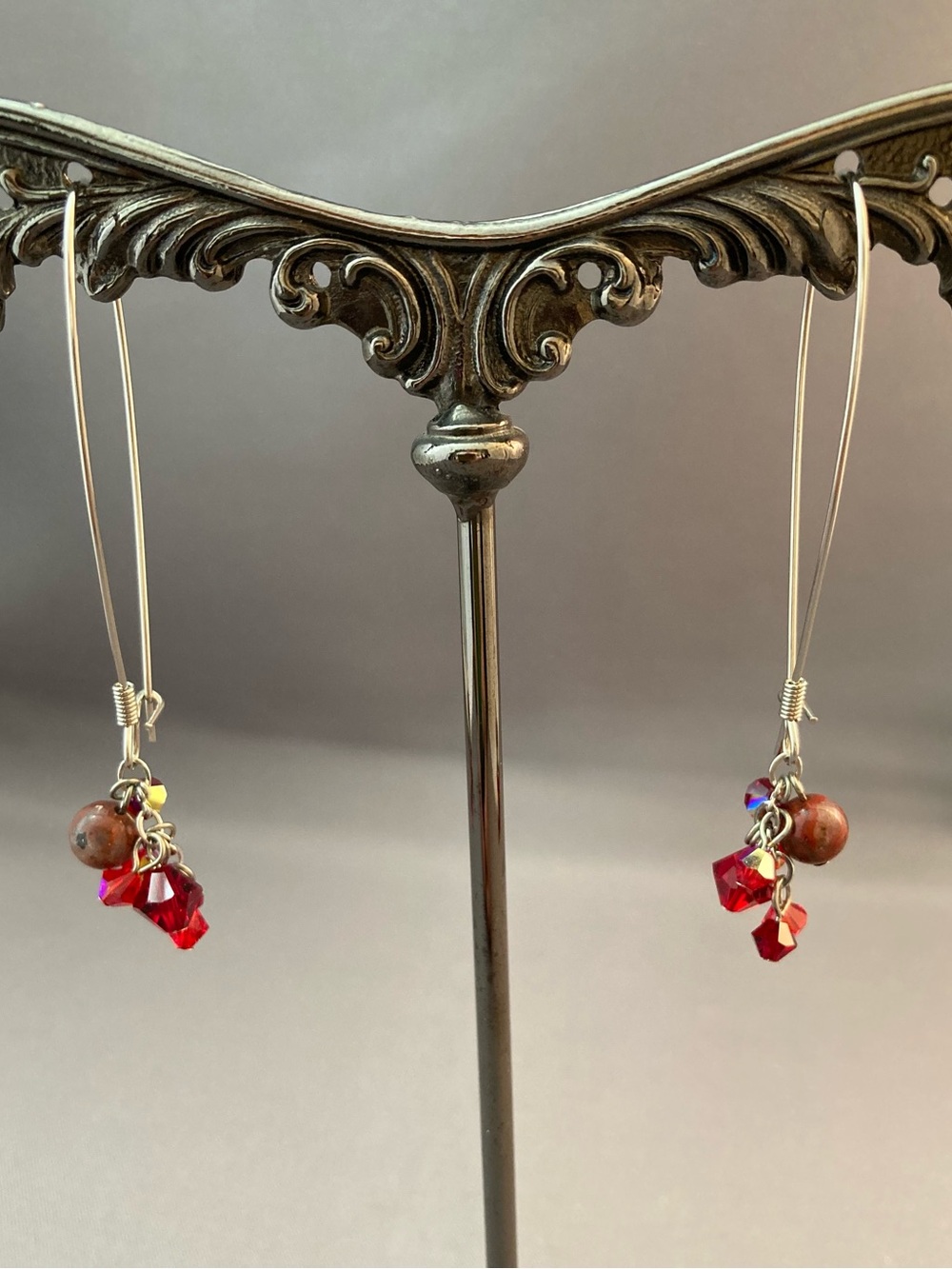 Silver tone metal red crystals long dangle earrings